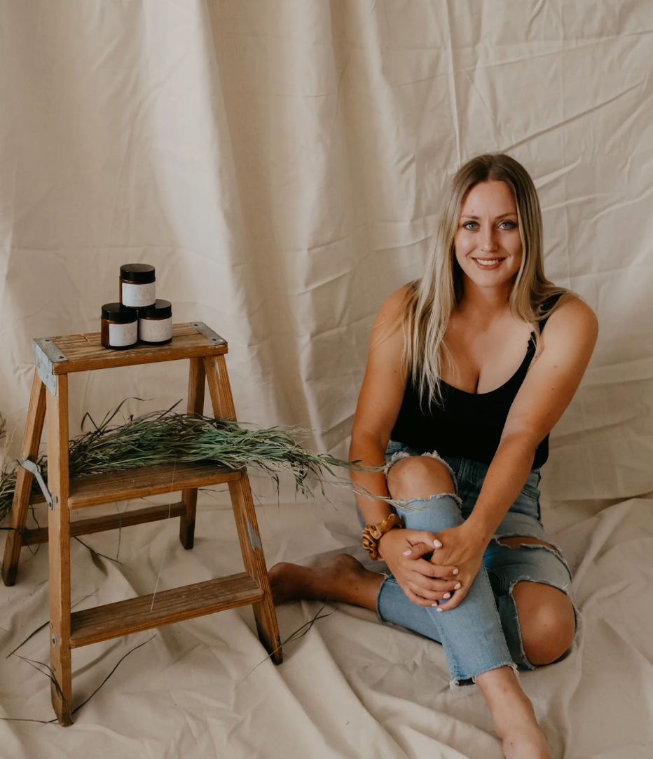 Canadian skincare company founder Kayla sitting next to products